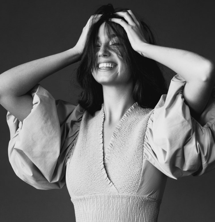 Woman with Hands in Hair Smiling Woman with Hands in Hair Smiling